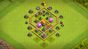 TH5 Anti-2 farming base layout in Clash of Clans with a diamond-shaped storage core, Bombs and Red Air Bombs to stop Wizard and Balloon raids.